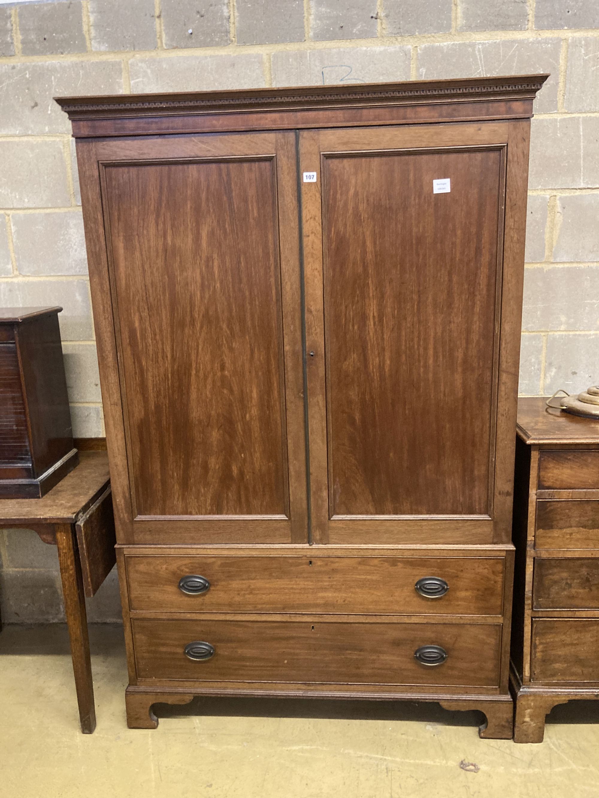 A George III style mahogany two door wardrobe, length 119cm, depth 56cm, height 183cm